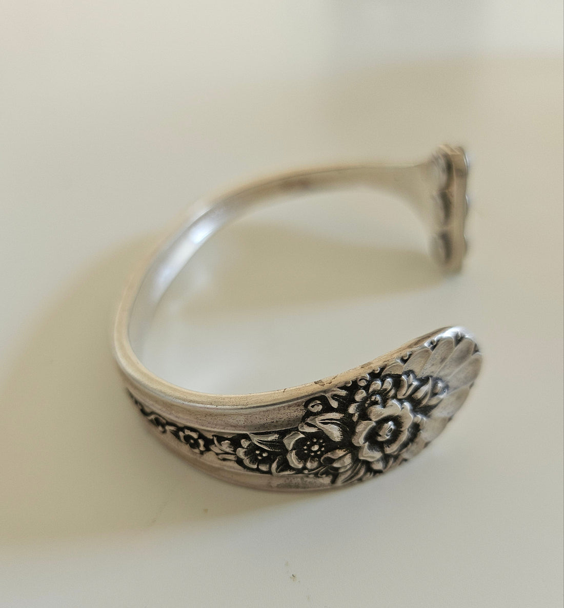 Handcrafted from 1953 Jubilee silverware, this vintage cuff bracelet features delicate floral details and pink crystals for a timeless, romantic sparkle