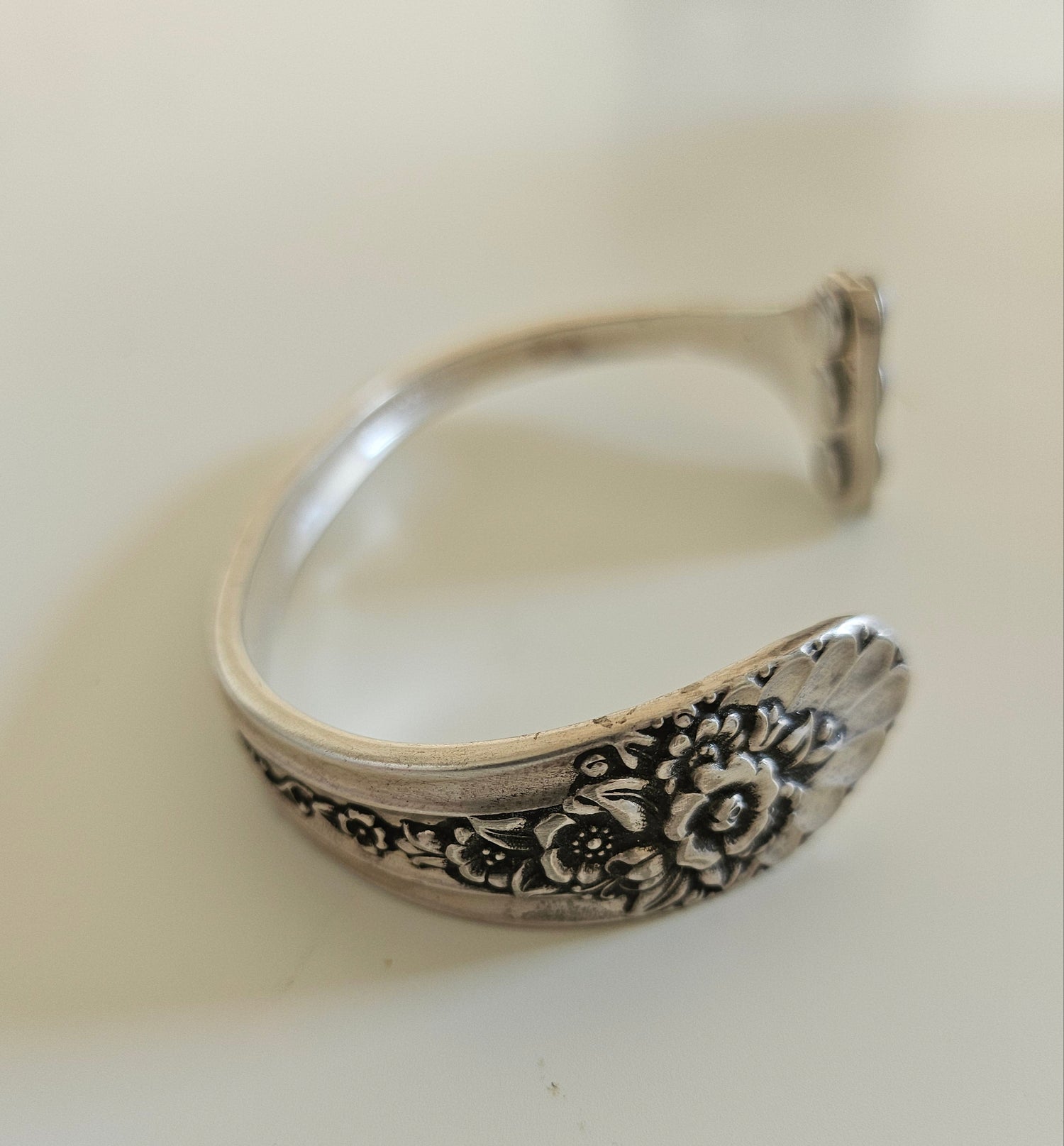 Handcrafted from 1953 Jubilee silverware, this vintage cuff bracelet features delicate floral details and pink crystals for a timeless, romantic sparkle