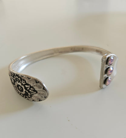 Handcrafted from 1953 Jubilee silverware, this vintage cuff bracelet features delicate floral details and pink crystals for a timeless, romantic sparkle