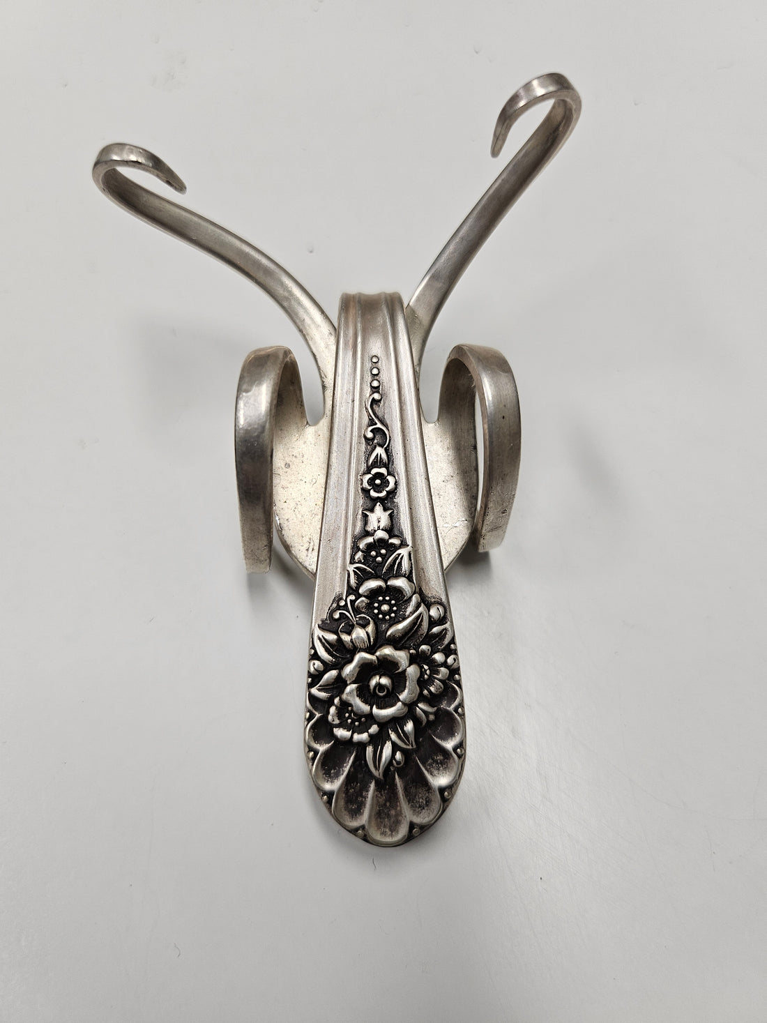 The Lucky Fork Cricket is a handcrafted sculpture made from repurposed vintage silverware, blending artistry with charm. Inspired by crickets—symbols of luck and prosperity—each piece is unique, adorned with jewels and aged patina. A perfect collectible or gift, this whimsical creation brings history, elegance, and positive energy to any space. 