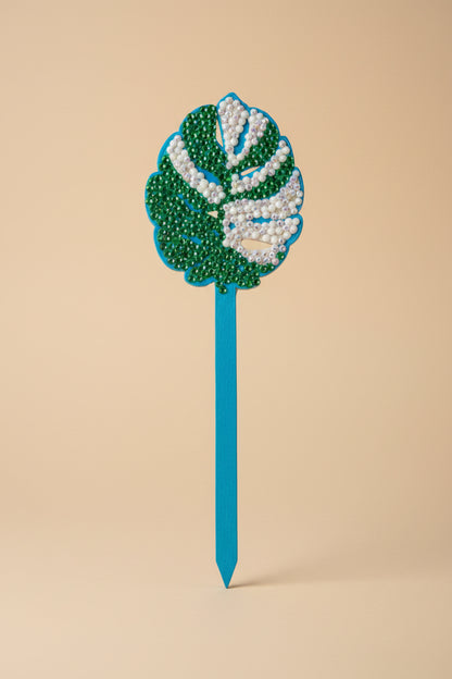 Bedazzled Monstera wooden plant stakes, hand-painted with sparkling details. Choose Monstera, Albo, Aurea or Thai Constellation for unique plant décor.
