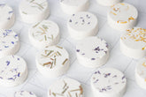 Aromatherapy shower steamer with essential oils. Biodegradable, handmade, and ultra-scented for a spa-like experience. Not for use as a bath bomb.
