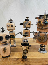 The Handmade Wood Block Steampunk Robot is a unique, decorative figurine crafted from wood with an aged, rustic look. Each robot is one-of-a-kind for display only. Includes a heart-shaped balloon. Available in various sizes, it&