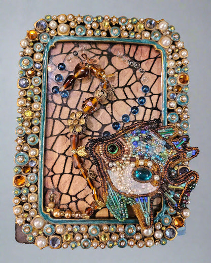 Add a splash of nautical charm with Jeweled Fish Frames, featuring handcrafted aquatic motifs in high-quality beads, glass, wood, and metal. These 4&quot; x 6&quot; frames blend intricate craftsmanship with vintage-inspired elegance, making them perfect for walls, shelves, or gallery displays. A unique decor statement!