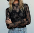 Elegant sheer mesh lace top with floral embroidery, mock neck & thumbhole sleeves. Perfect for layering or nights out. Romantic & versatile style.