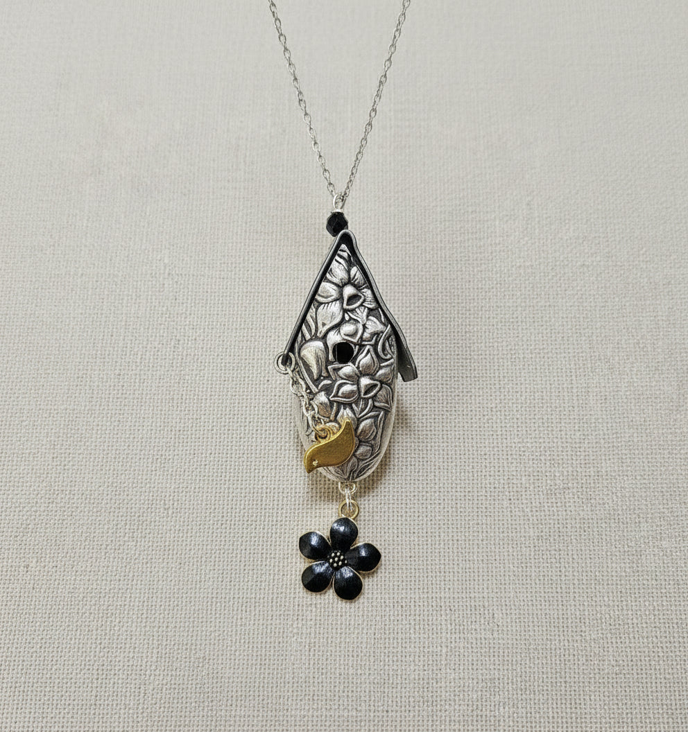 Handcrafted silver birdhouse pendant made from vintage silverware. A whimsical, one-of-a-kind necklace perfect for nature lovers and vintage jewelry fans.