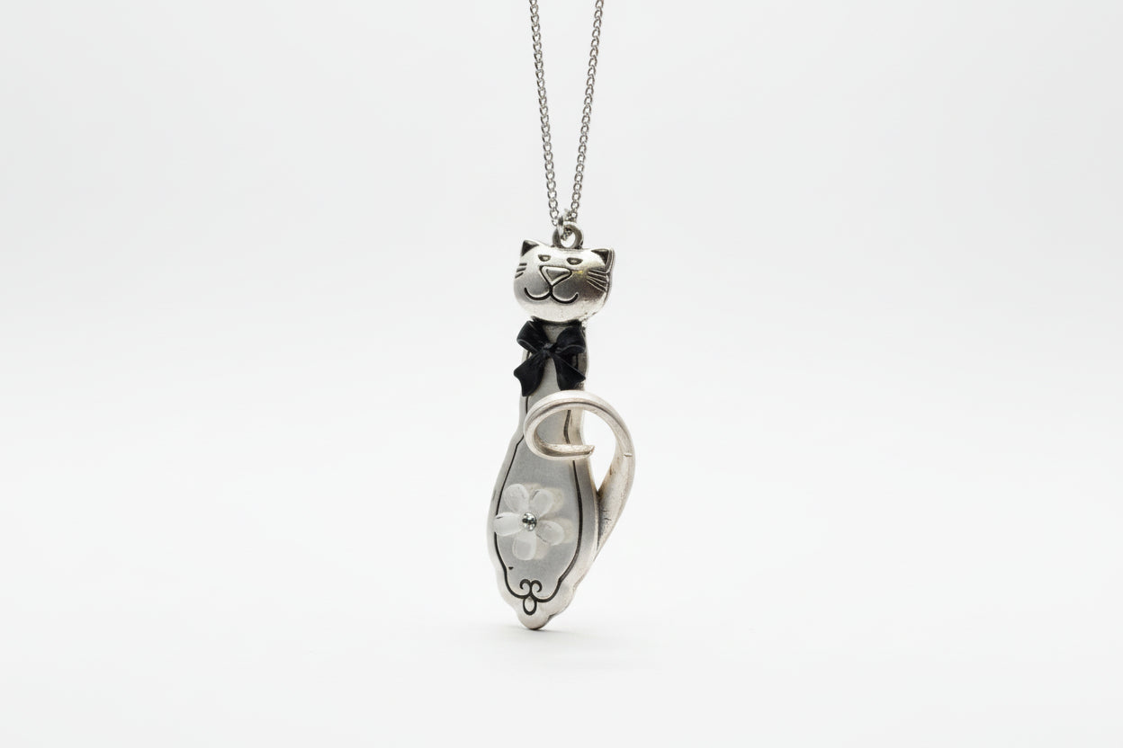 Handmade silver cat pendant necklaces from vintage silverware. Elegant, whimsical, and adjustable on a satin cord. Sustainably crafted and one-of-a-kind.