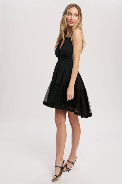 Black gauze swing mini dress with halter tie bust, backless design, elastic waist, and mesh ruffle hem. Lightweight summer party dress.