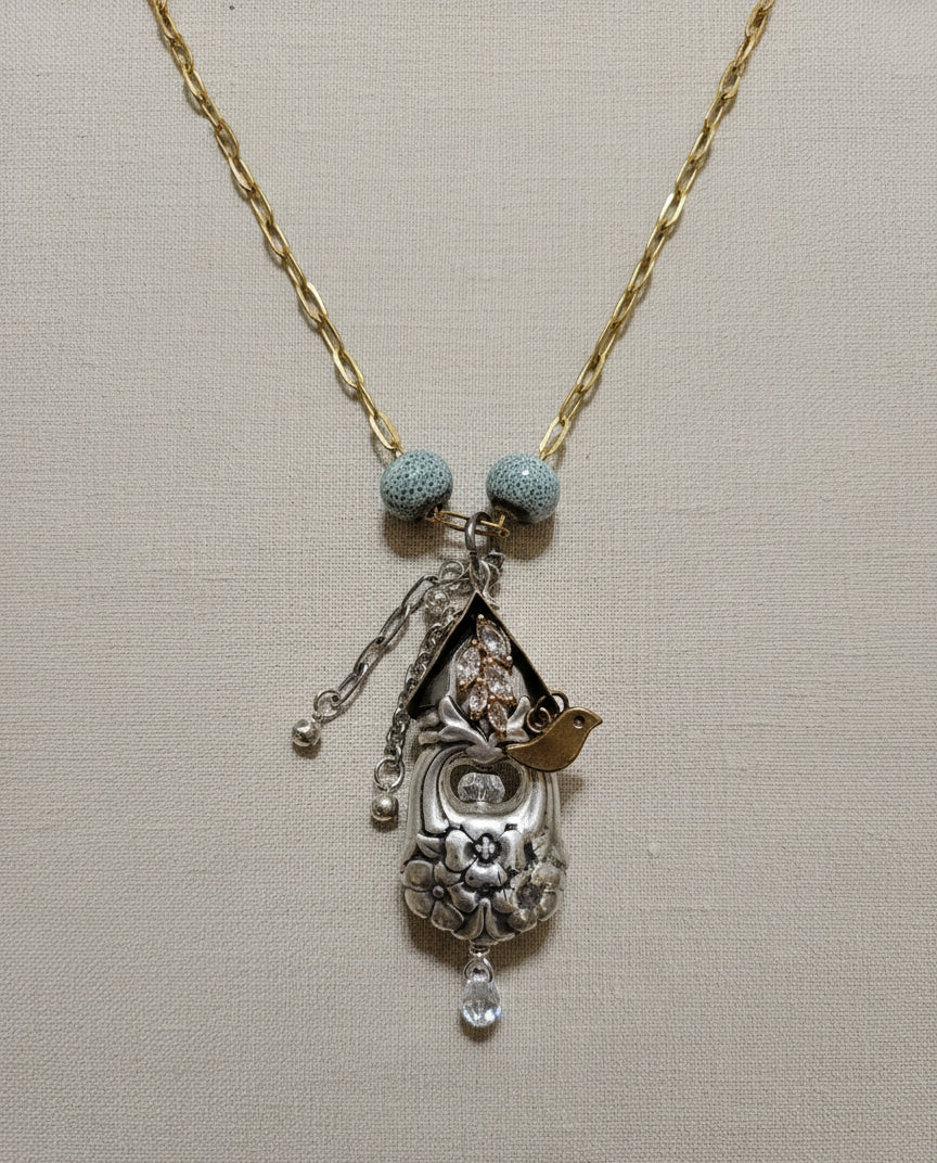 Handcrafted silver birdhouse pendant made from vintage silverware. A whimsical, one-of-a-kind necklace perfect for nature lovers and vintage jewelry fans.