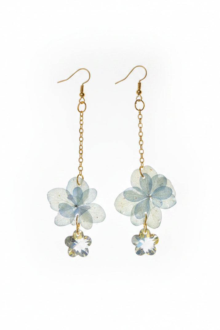 Real dried flower drop earrings preserved in resin with sparkling crystal accents. Romantic botanical jewelry with a delicate, one-of-a-kind garden feel.
