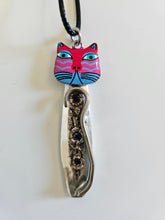 Handcrafted vintage silverware necklaces featuring enamel cat faces on adjustable satin cords. Made from 1951 Distinction and 1952 Primrose patterns.