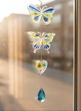 Handmade butterfly suncatchers with real pressed flowers and crystal chain. Reflects sunlight into rainbows—perfect for windows or near plants.