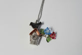 Handcrafted small birdhouse necklace made from reclaimed vintage silverware. Whimsical, cottagecore, eco-friendly jewelry perfect for nature lovers and unique gift giving.