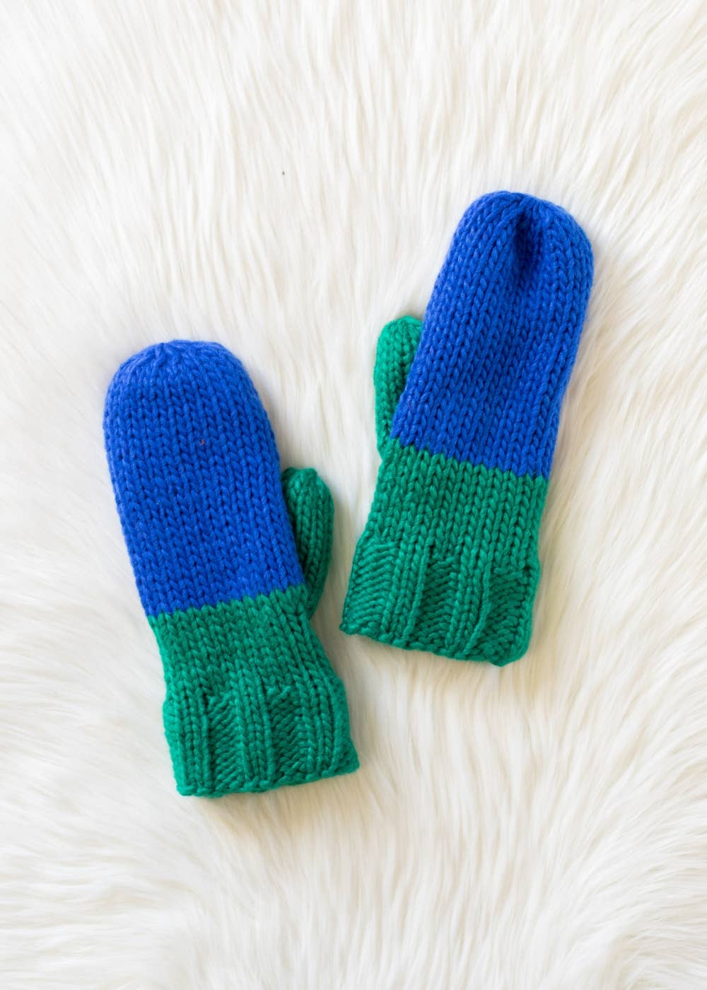 Blue and green color block knit mittens by Panache Apparel Co. Made from 100% acrylic with cozy fleece lining for warmth and colorful winter style.