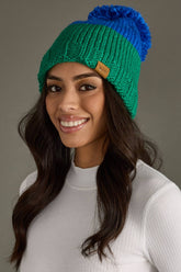 Blue and green color block pom hat by Panache Apparel Co. Made from 100% acrylic with cozy fleece lining and a large pom for cheerful winter style.