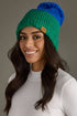 Blue and green color block pom hat by Panache Apparel Co. Made from 100% acrylic with cozy fleece lining and a large pom for cheerful winter style.