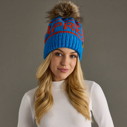 Blue and orange Après knit hat with a natural-toned faux fur pom and cozy fleece lining. Made from 100% acrylic for colorful, comfortable winter style.