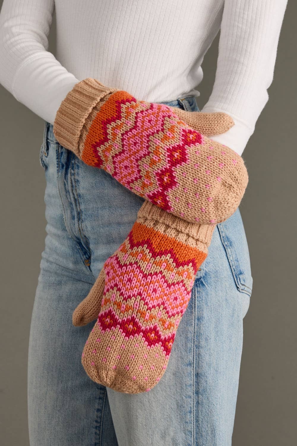 Blush, pink, orange & light pink patterned knit mittens with cozy fleece lining. Made from 100% acrylic for warmth, comfort, and playful winter style.