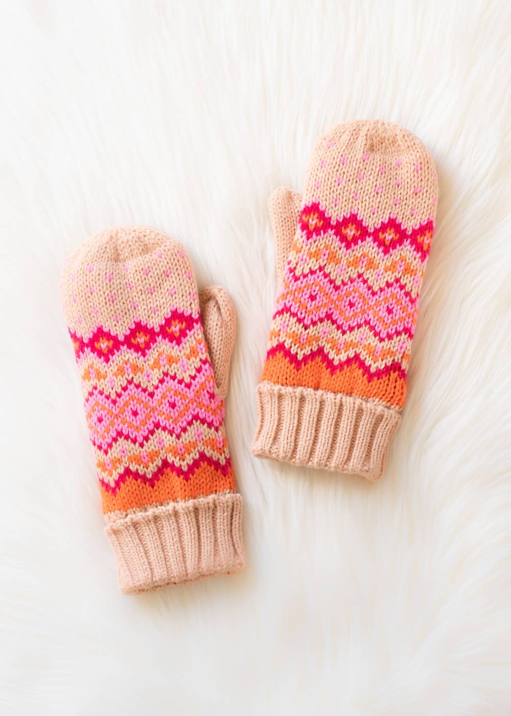 Blush, pink, orange & light pink patterned knit mittens with cozy fleece lining. Made from 100% acrylic for warmth, comfort, and playful winter style.