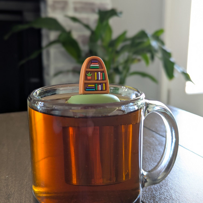 Plant Bookshelf Tea Steeper makes loose leaf tea easy in any cup. Reusable, dishwasher safe, eco-friendly. A perfect gift for tea and book lovers.