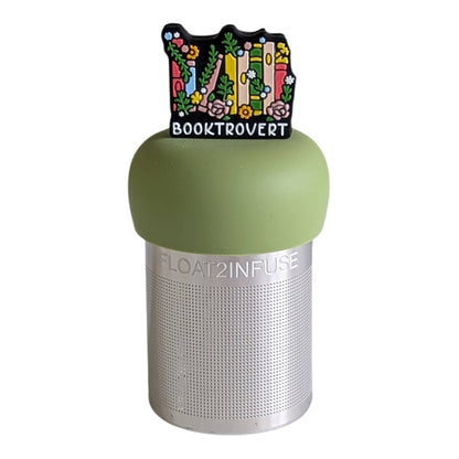 Booktrovert floating tea infuser with stainless-steel mesh and silicone top. Cute, reusable, dishwasher-safe steeper perfect for book lovers and loose-leaf tea.