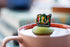 Booktrovert floating tea infuser with stainless-steel mesh and silicone top. Cute, reusable, dishwasher-safe steeper perfect for book lovers and loose-leaf tea.