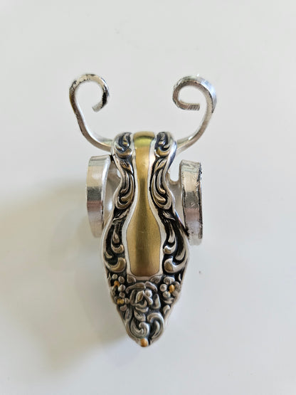 The Lucky Fork Cricket is a handcrafted sculpture made from repurposed vintage silverware, blending artistry with charm. Inspired by crickets—symbols of luck and prosperity—each piece is unique, adorned with jewels and aged patina. A perfect collectible or gift, this whimsical creation brings history, elegance, and positive energy to any space. 