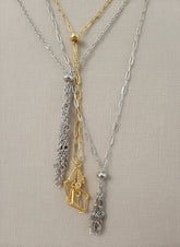 A versatile Crystal and Rock Cage Necklace with an adjustable metal pendant. Swap in your favorite gemstones or charms for a personalized, mystical accessory.