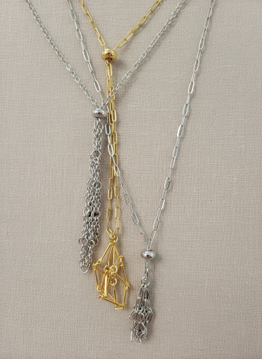 A versatile Crystal and Rock Cage Necklace with an adjustable metal pendant. Swap in your favorite gemstones or charms for a personalized, mystical accessory.