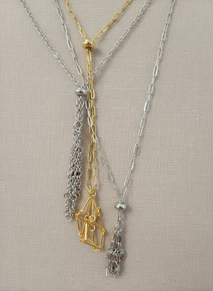 A versatile Crystal and Rock Cage Necklace with an adjustable metal pendant. Swap in your favorite gemstones or charms for a personalized, mystical accessory.
