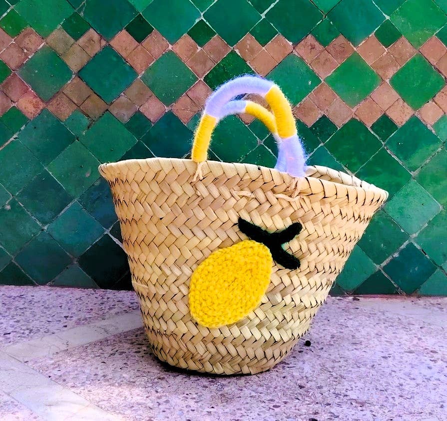 Cheerful straw tote with crocheted lemon patch and colorful handles. Lightweight, eco-friendly, and perfect for markets, beach days, or sunny adventures.