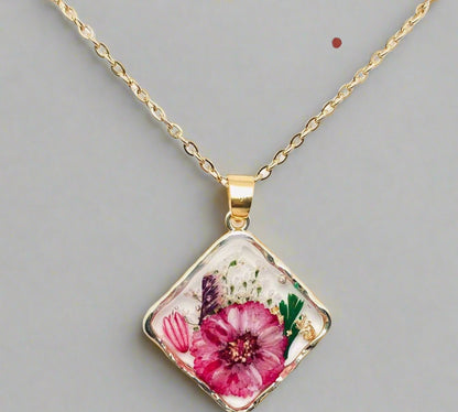 Handcrafted square pendant necklace with real pressed dried flowers in clear resin. Unique botanical jewelry with stainless steel chain and copper frame.
