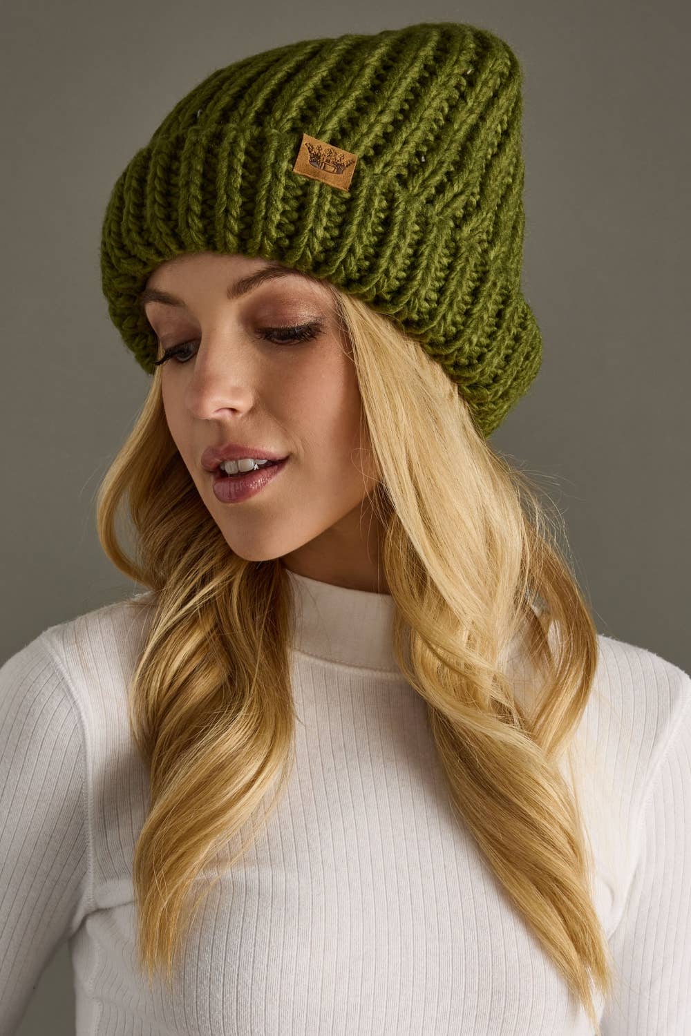 Olive chunky knit cuffed beanie with cozy fleece lining. Made from 100% acrylic, this classic winter hat adds warmth and earthy style to chilly days.