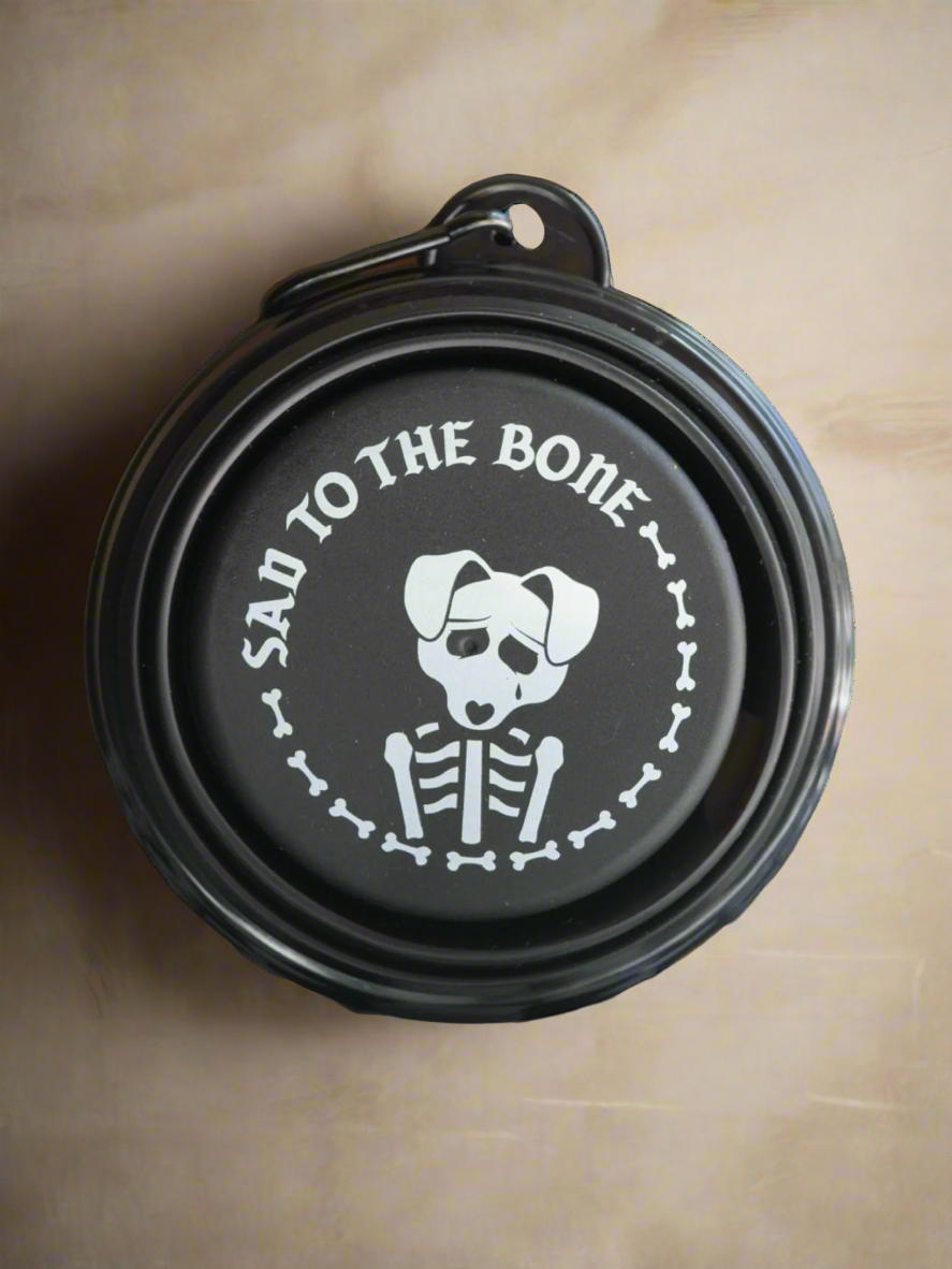 Collapsible Pet Bowl – 5&quot; silicone travel dog bowl with carabiner. Black with white “Sad to the Bone” graphic. Portable, lightweight &amp; perfect for pets.