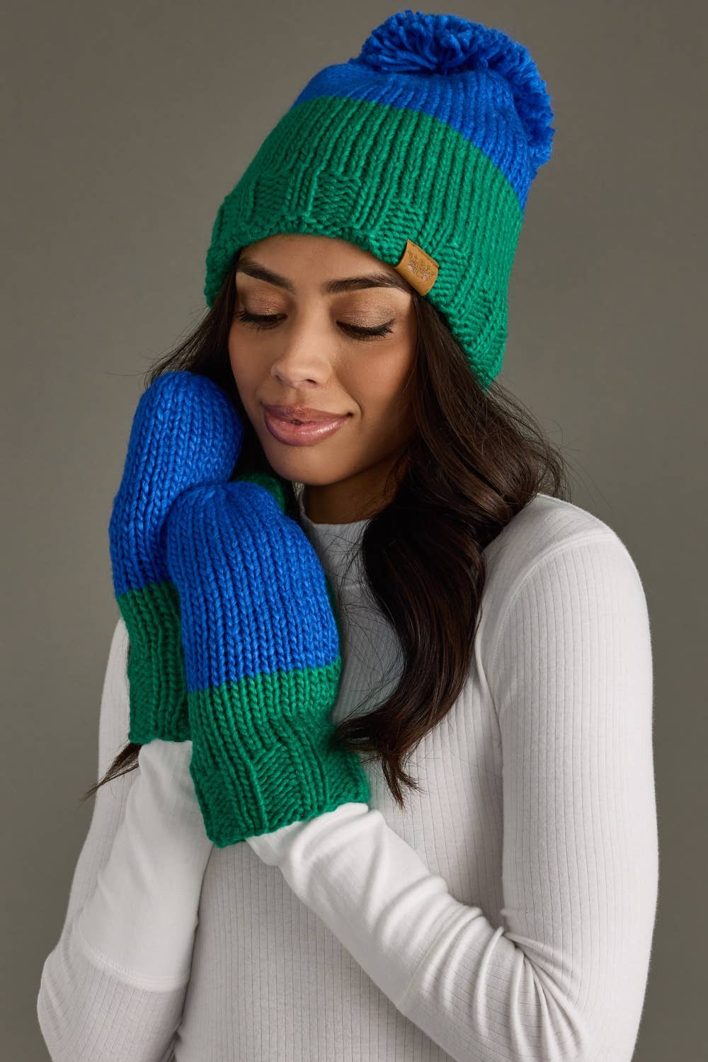 Blue and green color block knit mittens by Panache Apparel Co. Made from 100% acrylic with cozy fleece lining for warmth and colorful winter style.