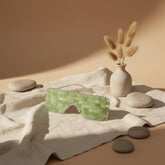 Cooling or warming jade eye mask made from 100% real jade beads. Reduces puffiness, soothes tension, boosts circulation, and brings calm, balance, and radiant renewal.