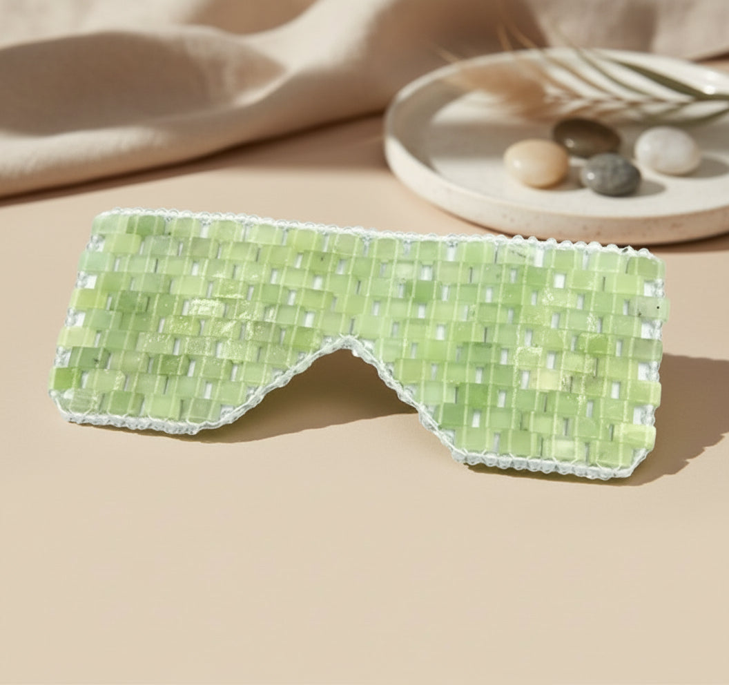 Cooling or warming jade eye mask made from 100% real jade beads. Reduces puffiness, soothes tension, boosts circulation, and brings calm, balance, and radiant renewal.
