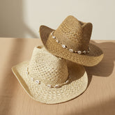 Cowrie Shell Band Cowboy Hat featuring woven paper straw texture and coastal boho western style. Lightweight, breathable, and perfect for beach days or festivals.