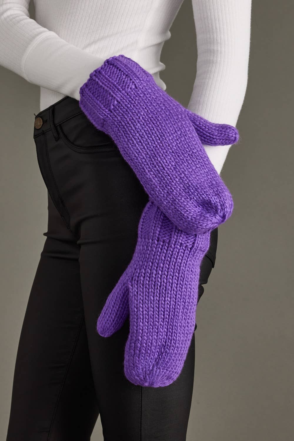 Cozy purple knit mittens with soft fleece lining for chilly days. Made from 100% acrylic and pairs with the matching hat for a colorful winter look.