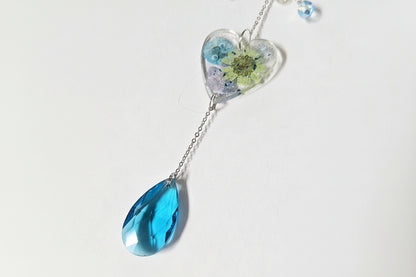 Handmade butterfly suncatchers with real pressed flowers and crystal chain. Reflects sunlight into rainbows—perfect for windows or near plants.