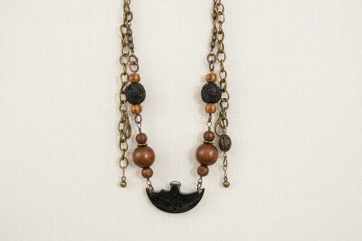 Layered antique-style chains with earthy beads and a charm tassel. The Nomad Layer Necklace is a soulful, wander-inspired statement.