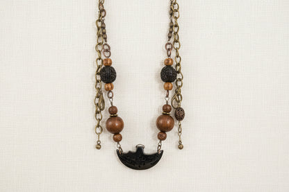 Layered antique-style chains with earthy beads and a charm tassel. The Nomad Layer Necklace is a soulful, wander-inspired statement.