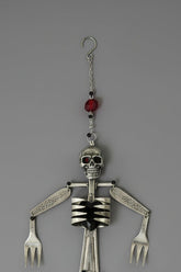 Skeleton Rattle & Bone Hanging Chime handcrafted from vintage silverware with crystal accent—whimsical skeleton wind chime with soft sound and one-of-a-kind charm.