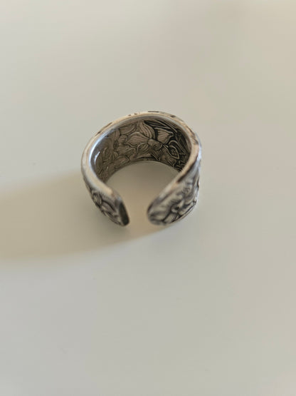 Handcrafted from 1935 Narcissus silverware, this adjustable floral ring by National Silver Co. brings vintage elegance and timeless charm to any outfit.