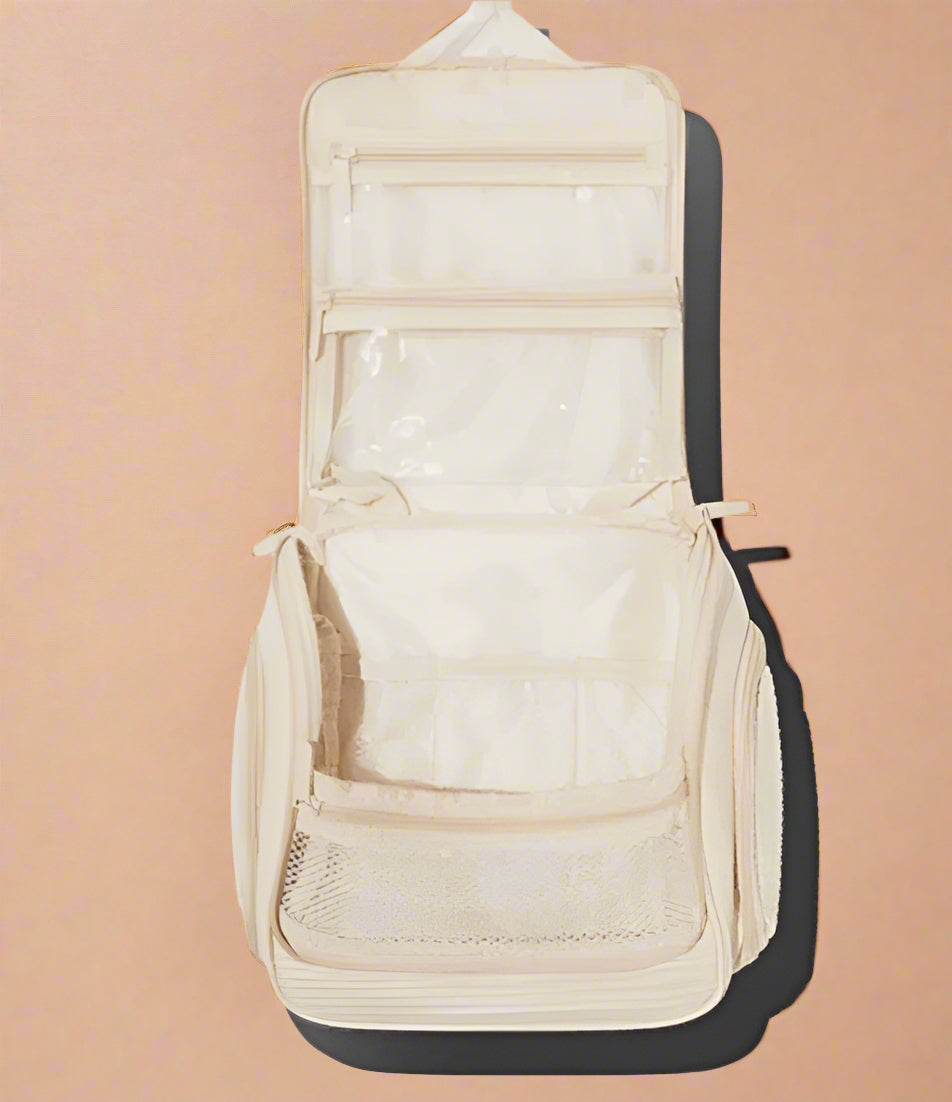 Spacious Dezi Skin travel bag with compartments, side pockets, 360° hook &amp; easy-clean lining. Fits full-size products—perfect for beauty, gym, or travel.
