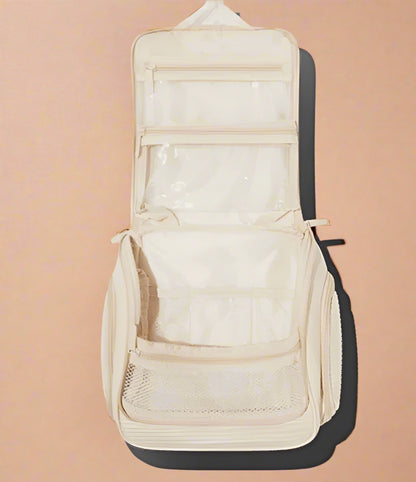 Spacious Dezi Skin travel bag with compartments, side pockets, 360° hook &amp; easy-clean lining. Fits full-size products—perfect for beauty, gym, or travel.
