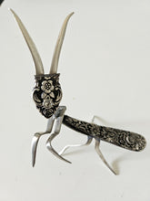 Handcrafted 5" x 4" praying mantis sculpture made from vintage silverware. Unique, whimsical art with gemstone accents and aged patina for mindful décor.