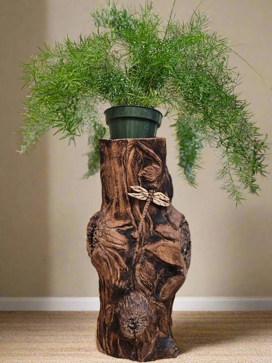 The Hand-Carved Dragonfly Outdoor Planter and Solar Light Wood Spirit in Solid Walnut (30" x 10"). 100% handmade, each piece is unique and perfect for home decor. The natural walnut grain and artisanal craftsmanship add rustic charm, making it a standout decorative piece for any space.