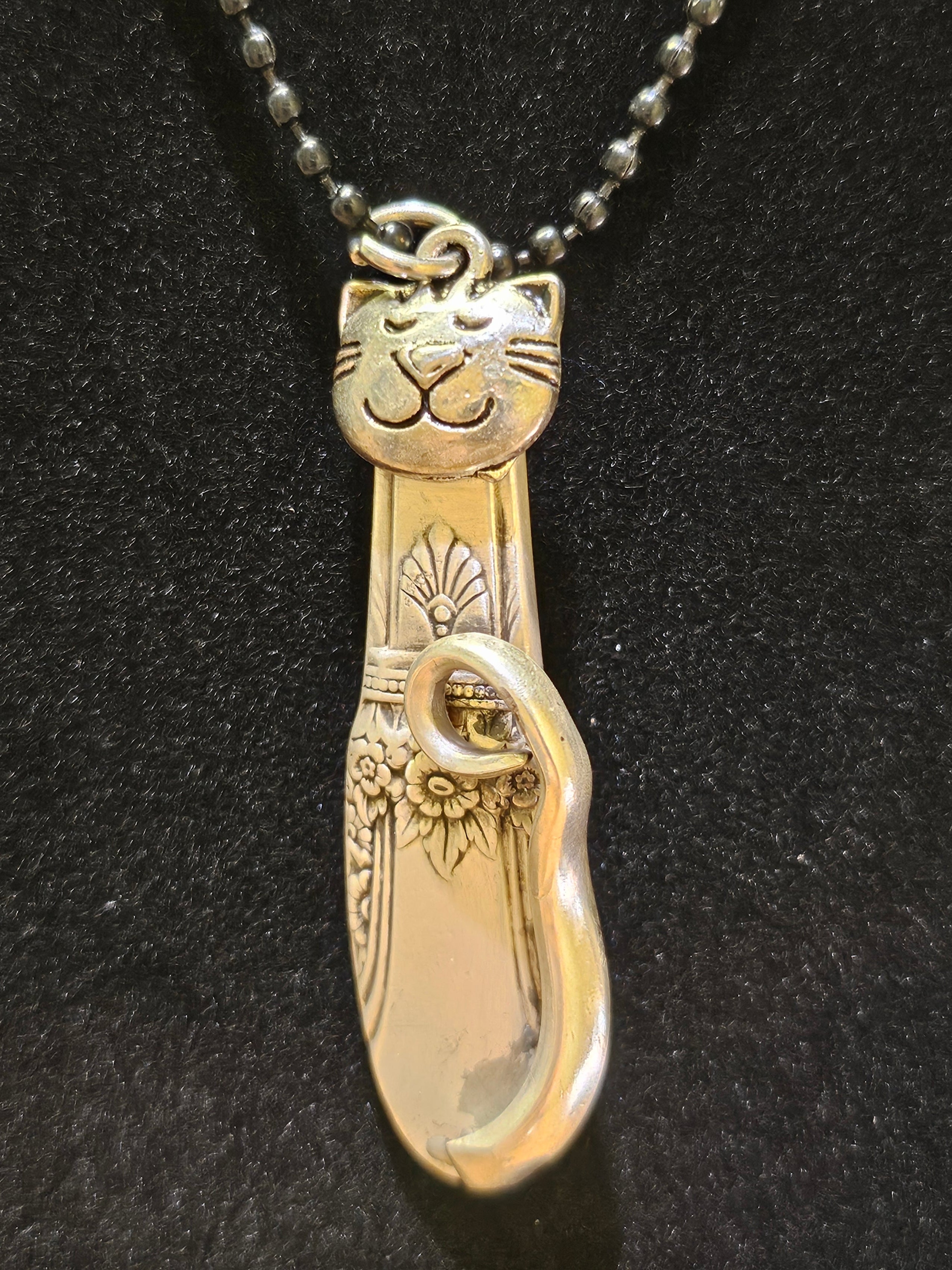 Handmade silver cat pendant necklaces from vintage silverware. Elegant, whimsical, and adjustable on a satin cord. Sustainably crafted and one-of-a-kind.