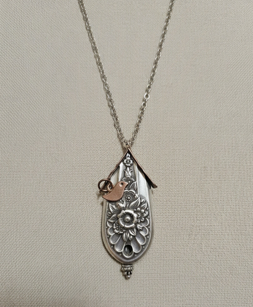 Handcrafted silver birdhouse pendant made from vintage silverware. A whimsical, one-of-a-kind necklace perfect for nature lovers and vintage jewelry fans.